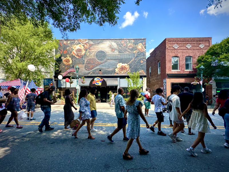 Pedestrians In Front of the 523 South Elm Street Mural